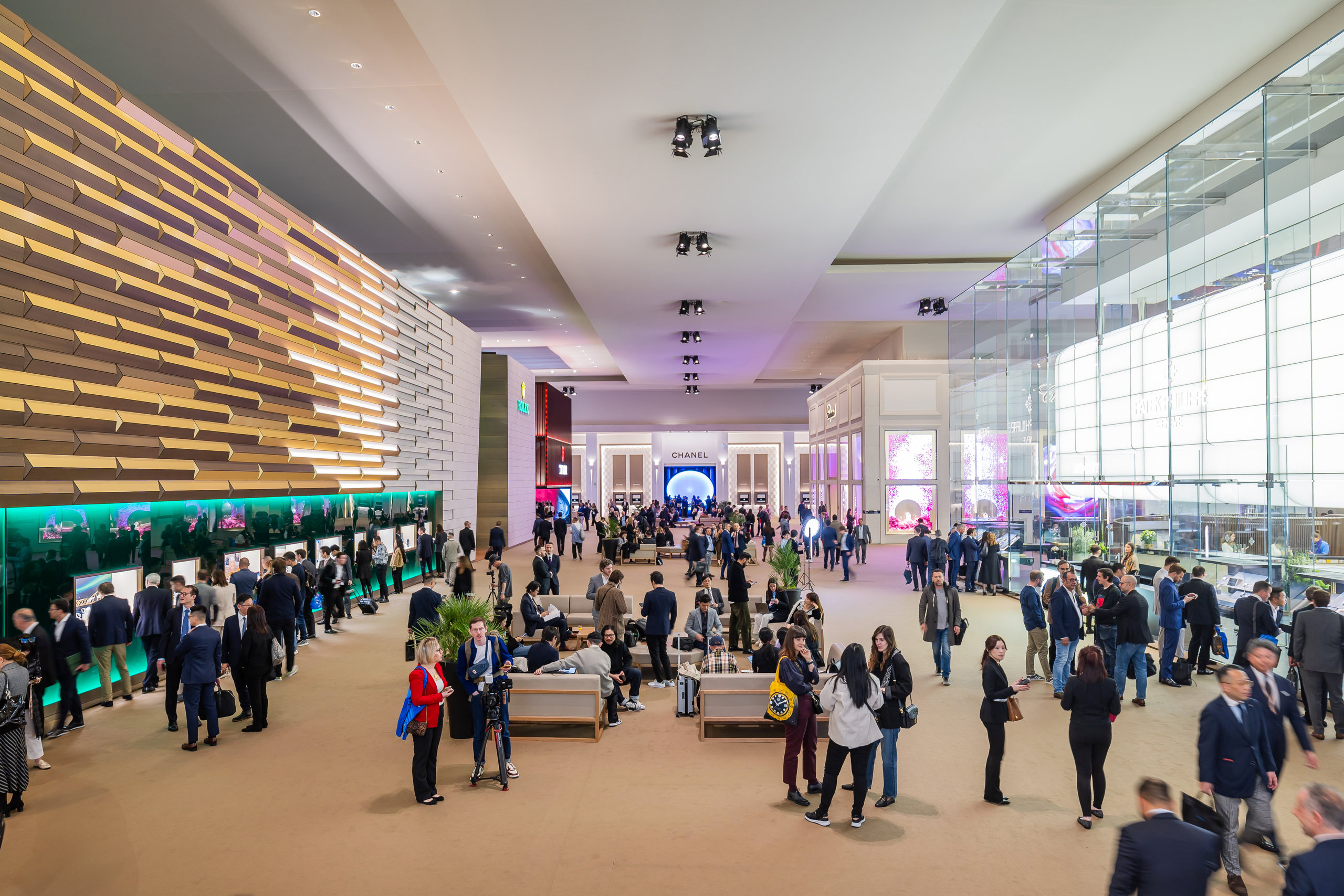 Guests exploring the bustling Watches and Wonders 2026 exhibition halls in Geneva