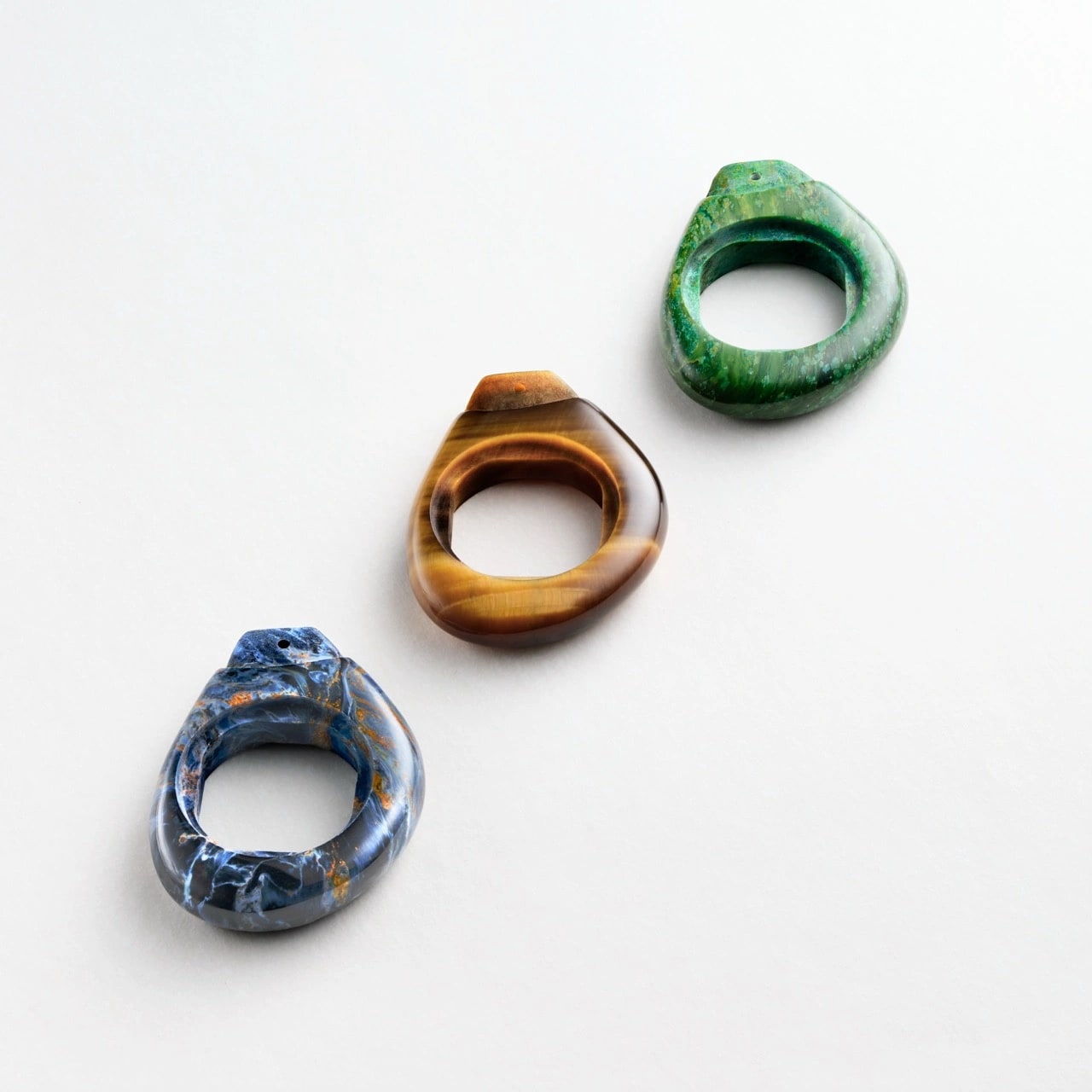 Piaget Swinging Pebbles sautoirs showcasing tiger’s eye, verdite and pietersite stones