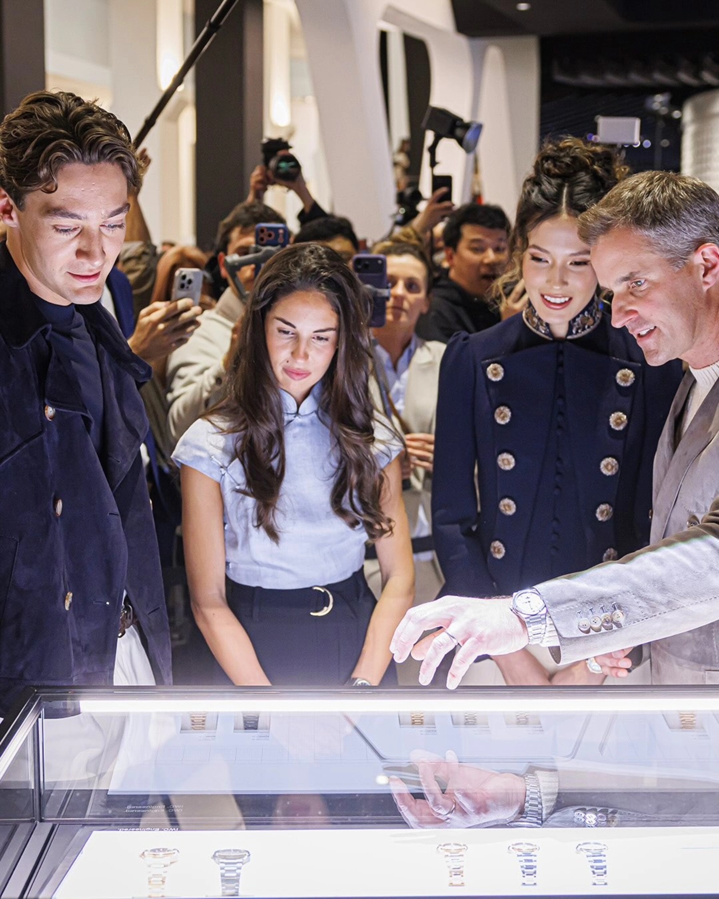Close-up of IWC brand ambassadors with Le Petit Prince timepieces at the Geneva fair