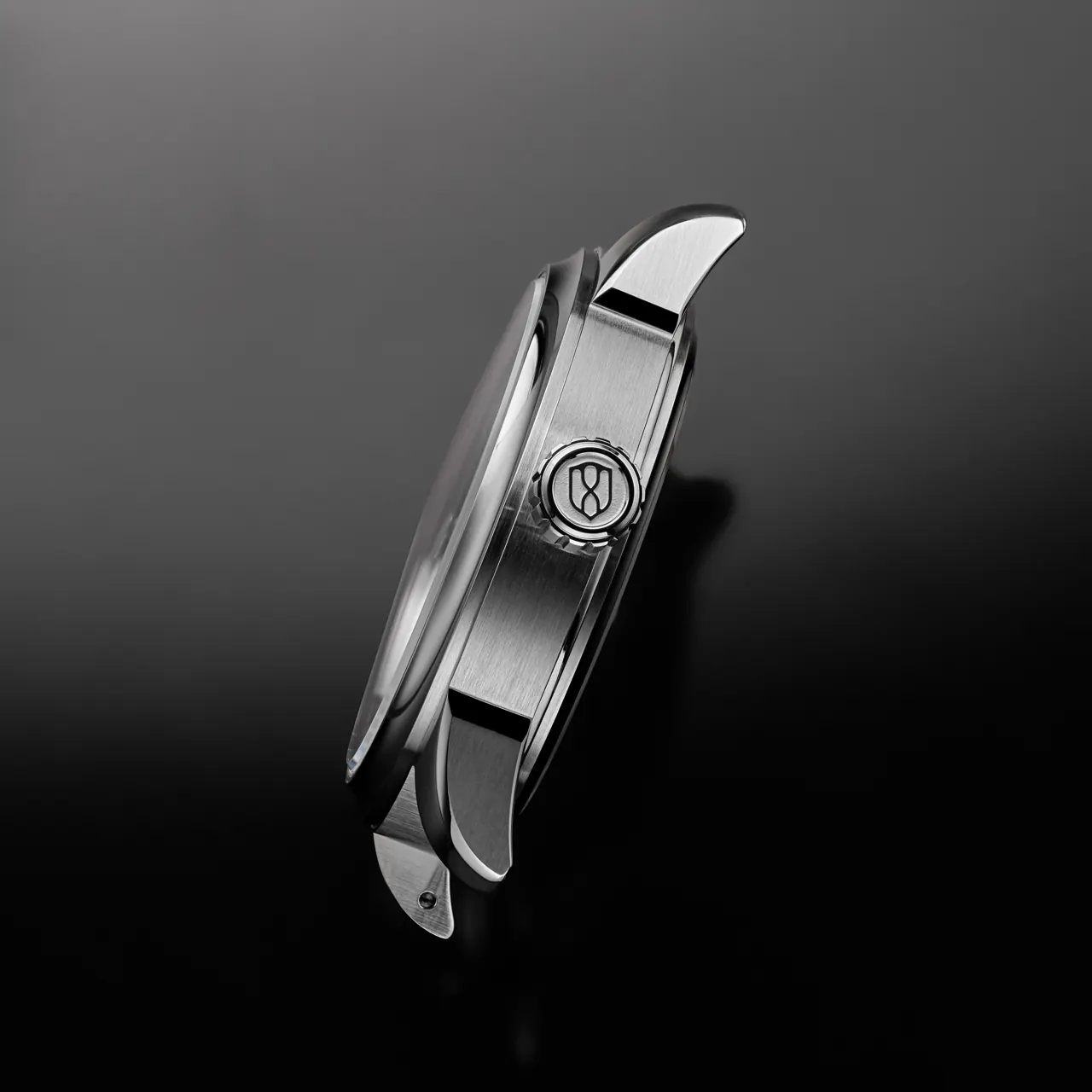 AWAKE 38mm case detail showing polished concave bezel and custom tungsten oscillating weight