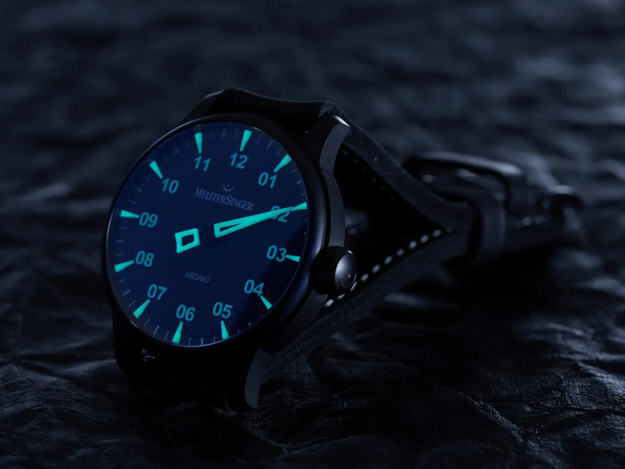 MeisterSinger Archao exhibition caseback with Archao script on volcano-inspired printed background