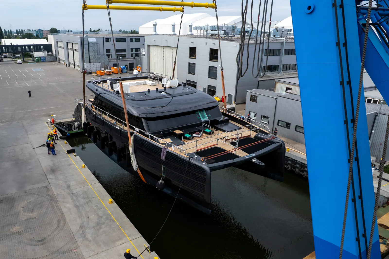 Sunreef 100 Eco sailing catamaran exterior view with integrated solar panels on hull and superstructure