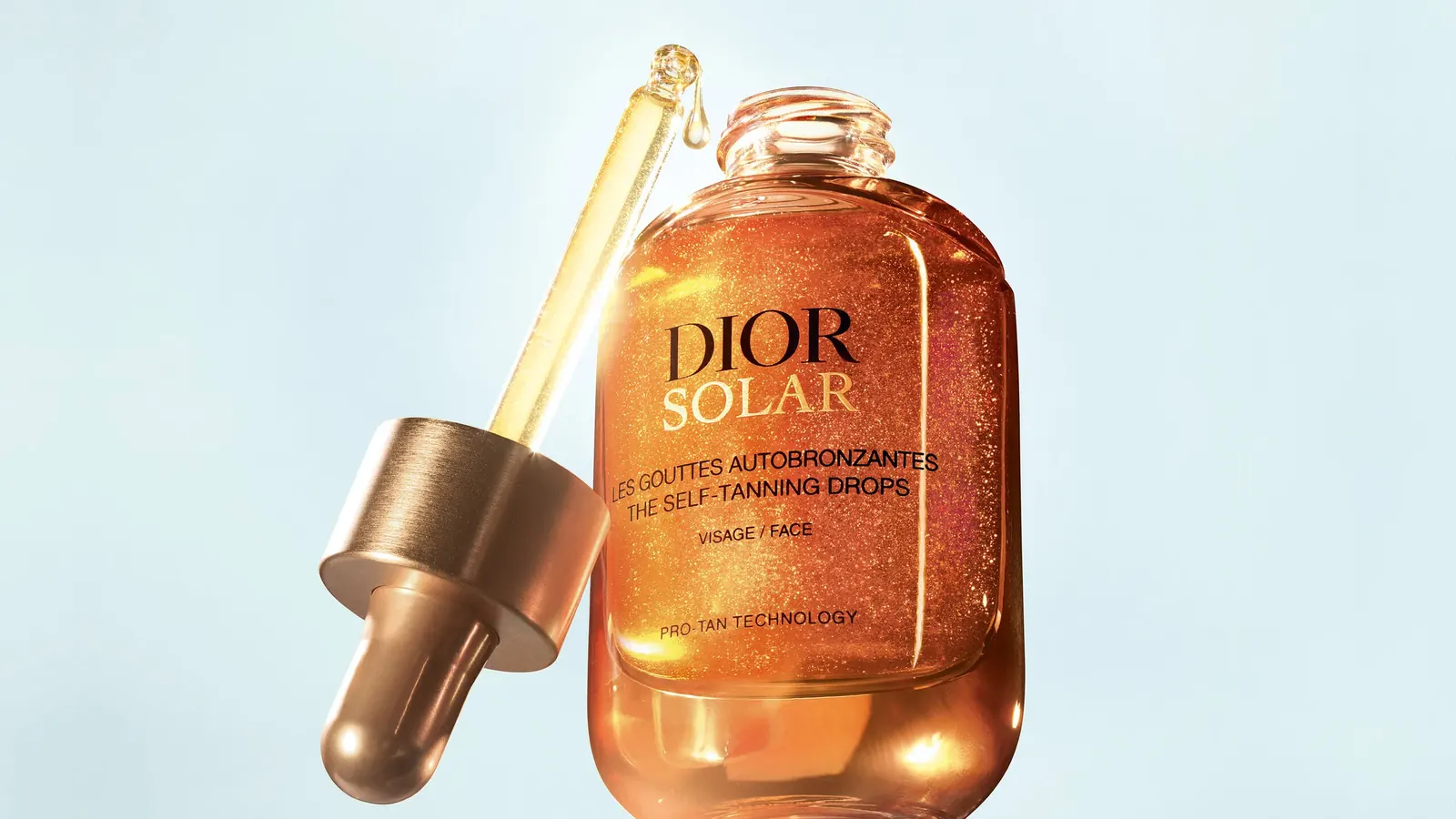 Close-up of Dior Solar Self-Tanning Drops serum texture showing fine golden pigments