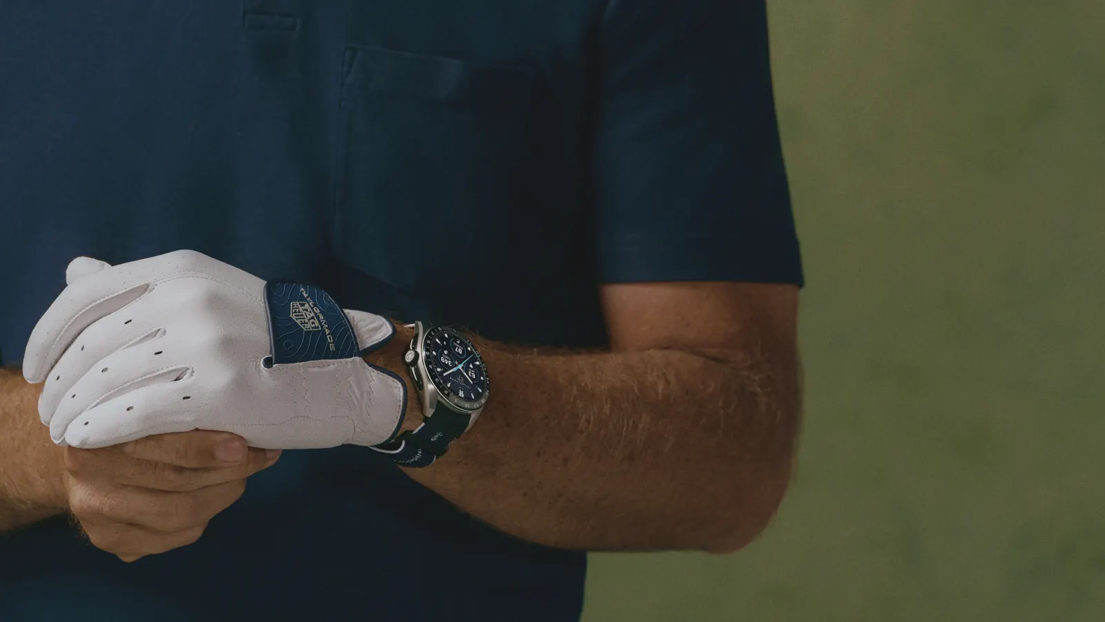 TAG Heuer x TaylorMade co-branded accessories including duffle bag and golf gloves