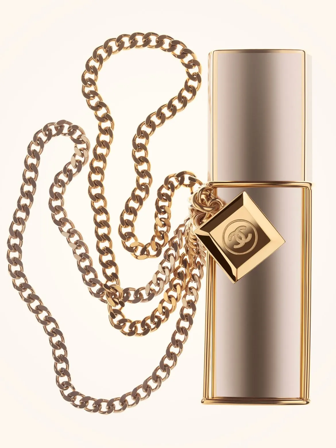 Three 20 ml Gabrielle Chanel Essence Eau de Parfum canisters laid beside metallic purse spray case