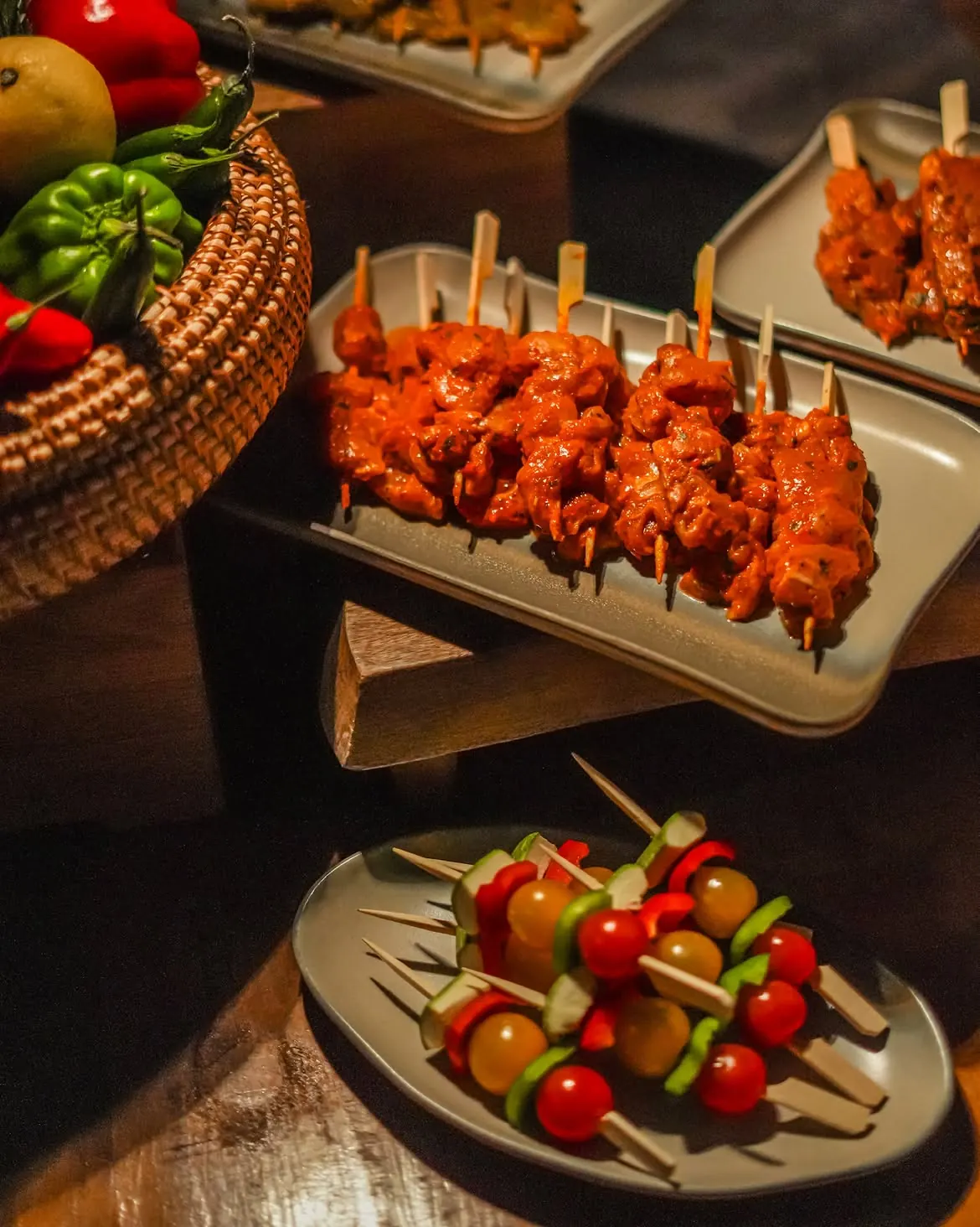 Open-fire grill at Six Senses Southern Dunes The Red Sea with guests dining beneath the Hijaz Mountains silhouette