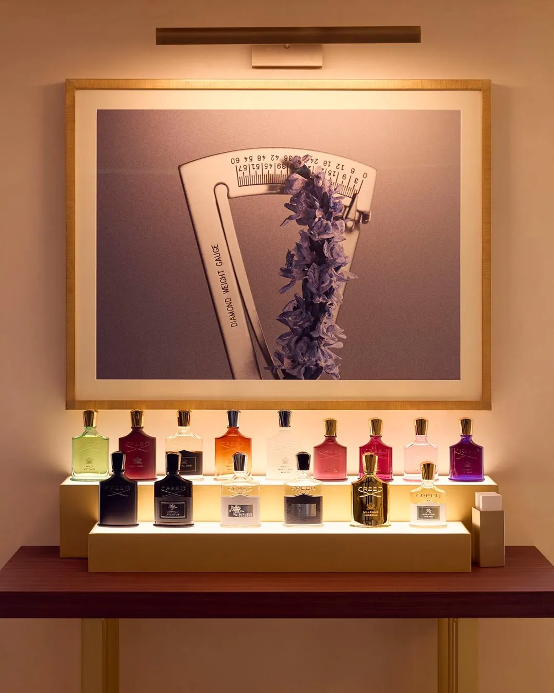 Brushed brass shelving and fragrance display at Creed's 211 Rue Saint-Honoré Paris flagship