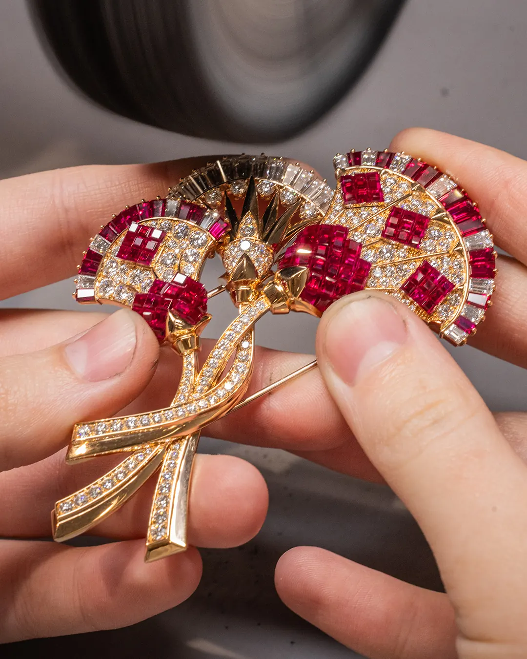 Close-up of Mystery Set ruby petals on the Fleur de Lotus Mysterieuse clip in rose and yellow gold