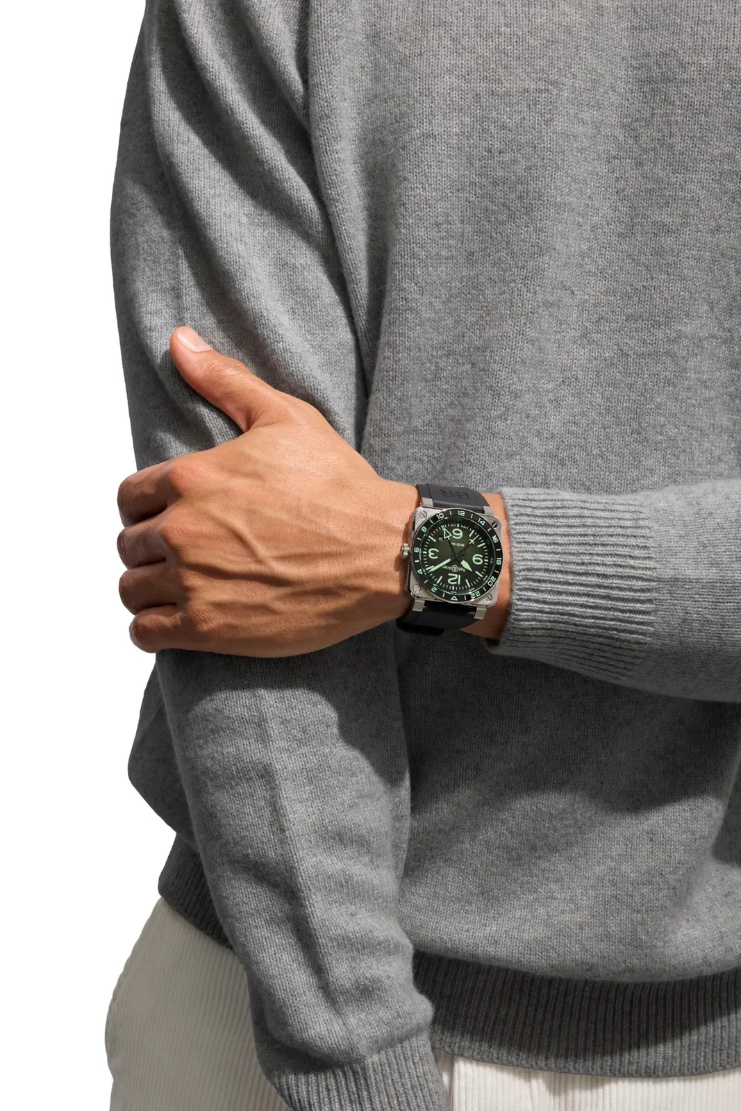 Bell & Ross BR-03 GMT Green Lum on black rubber strap showing GMT hand and 24-hour scale