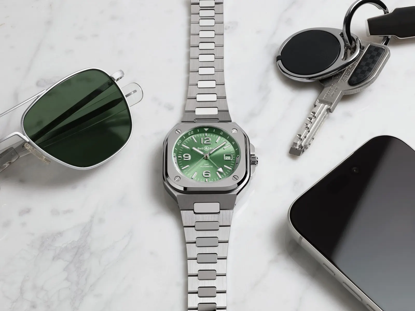 Bell & Ross BR-05 GMT Green Steel sage sunray dial close-up showing arrow GMT hand and two-tone flange