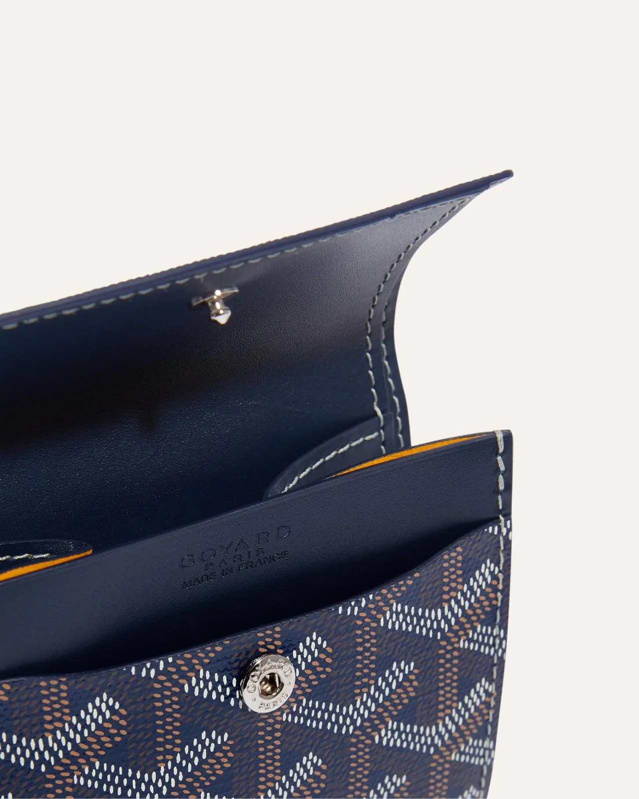 Goyard Matignon wallet in yellow, showing zip closure and multiple card slots