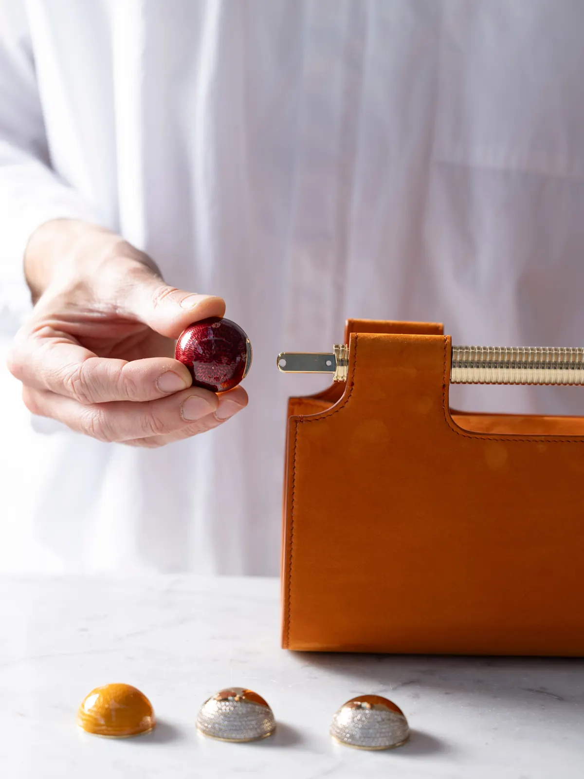 Bvlgari Tubogas Spheres clutch in terracotta Nabuk sueded leather, FW 2026