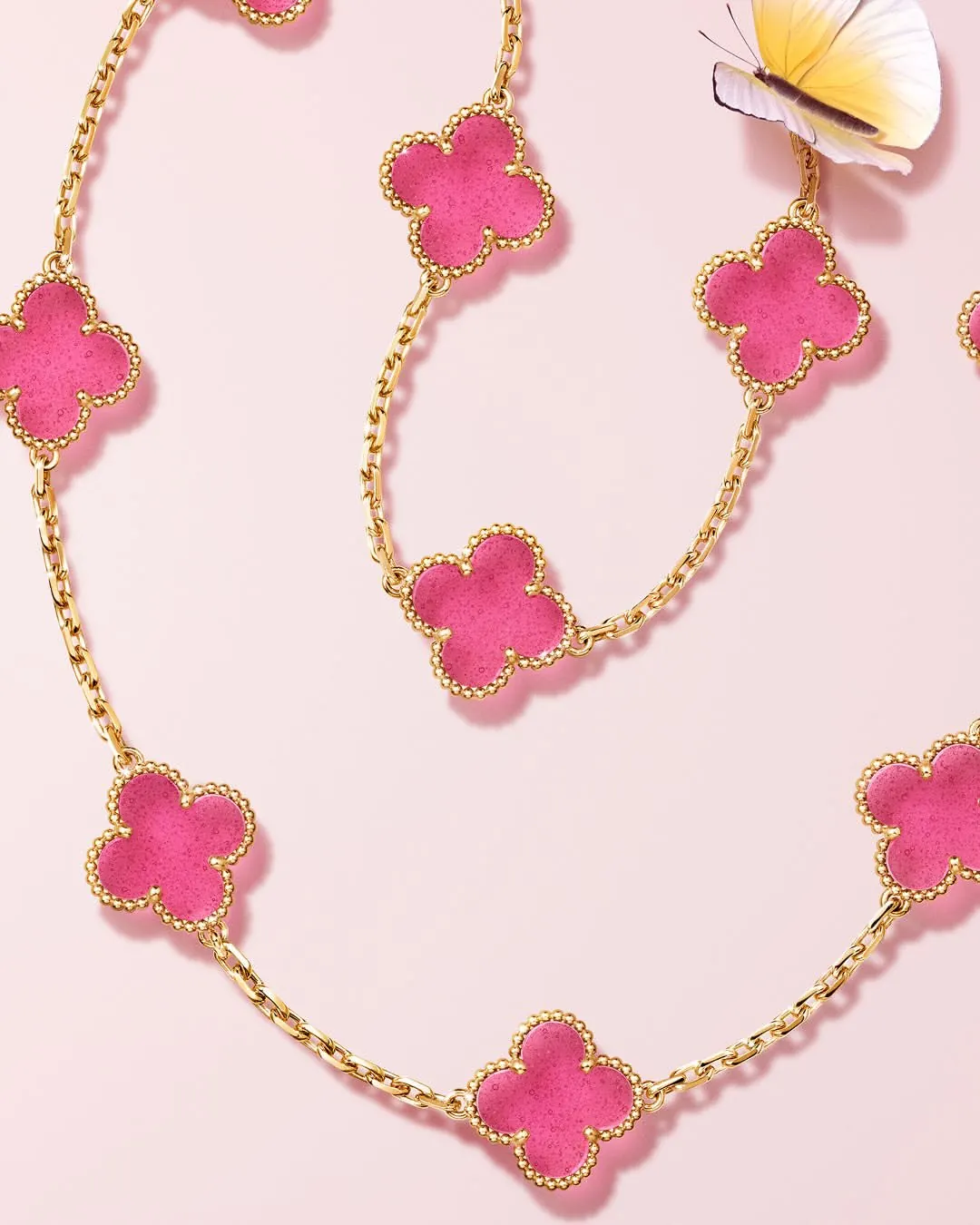 Translucent pink enamel clover motif showing tiny bubble inclusions on Alhambra bracelet
