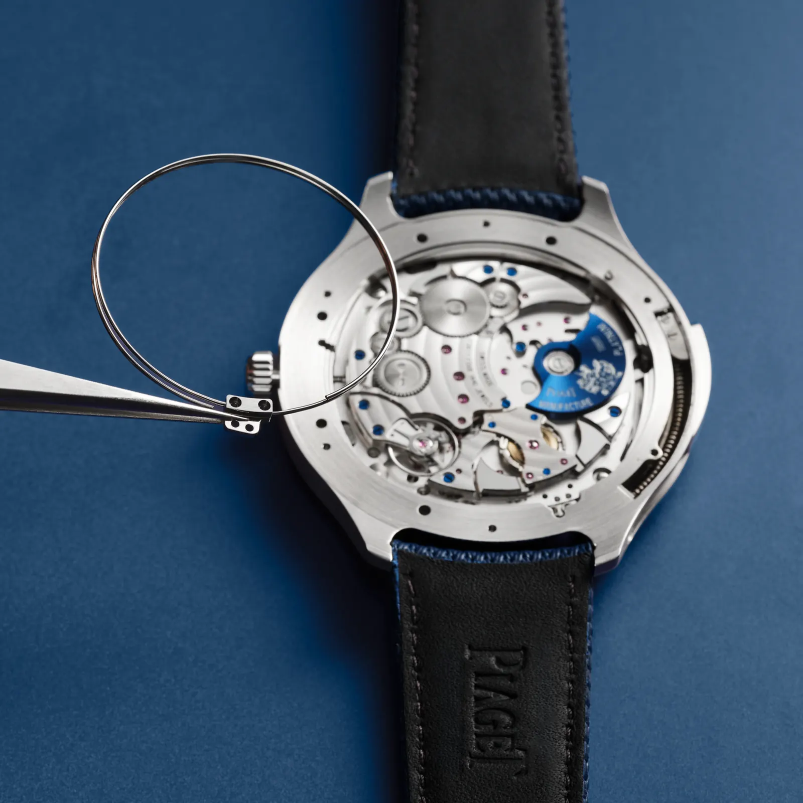 Calibre 1290P platinum micro-rotor with blue PVD coating visible through openworked dial