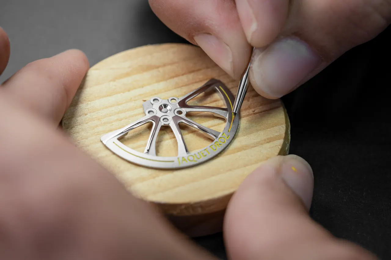 Jaquet Droz oscillating weight machined as a six-spoke white-gold wheel rim with helical geometry