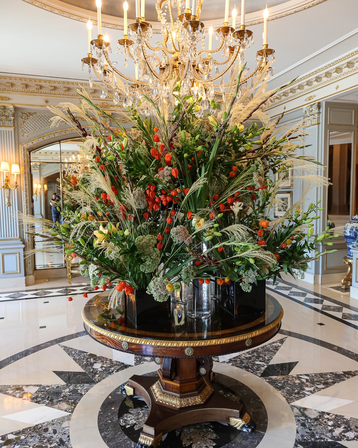 Lobby of the Four Seasons Hotel des Bergues in Geneva with chandelier and flowers