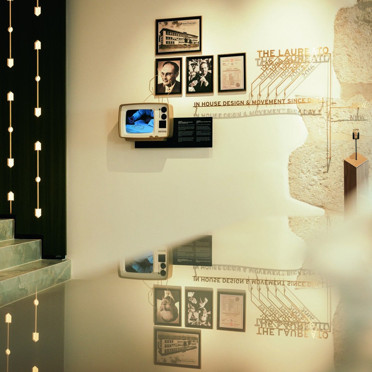 Heritage wall of the Girard-Perregaux Geneva maison with archive photographs and the Laureato story, official image