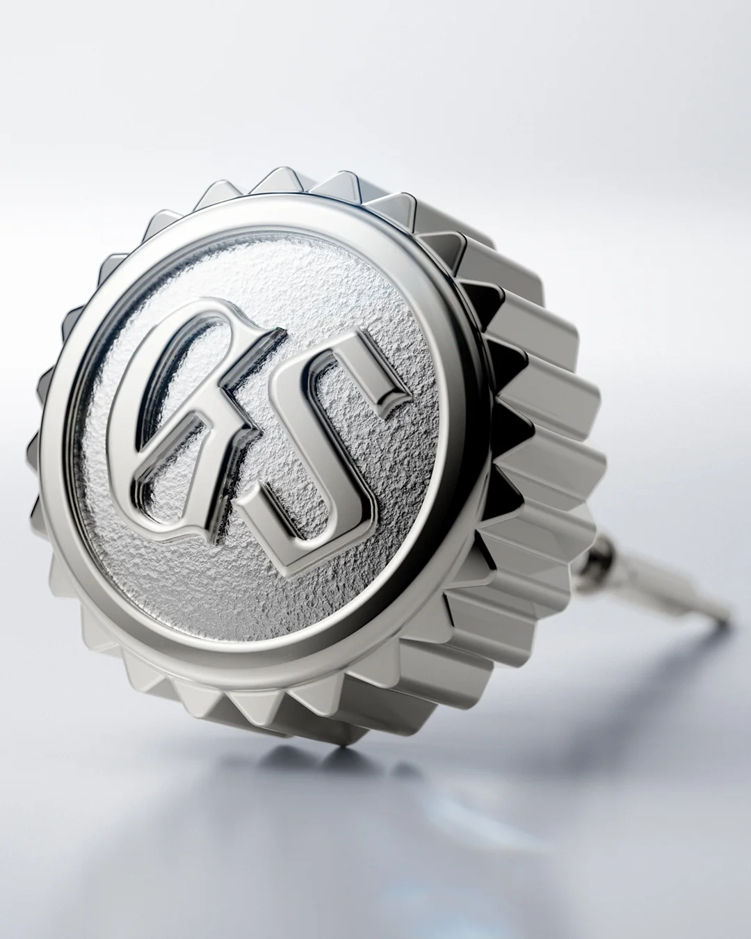 Macro photograph of a polished Grand Seiko crown engraved with the GS emblem