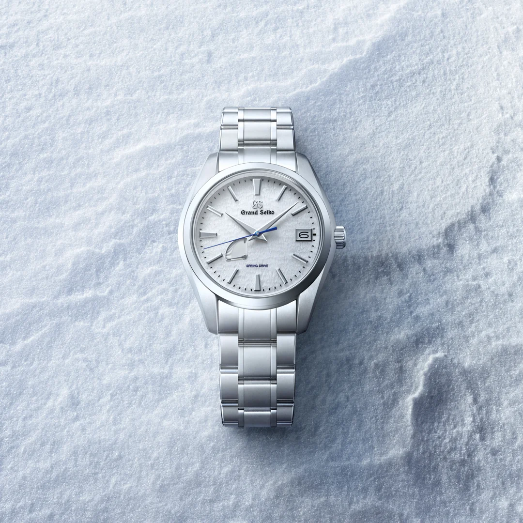 Grand Seiko Heritage Spring Drive with white Snowflake dial and titanium bracelet photographed on fresh snow