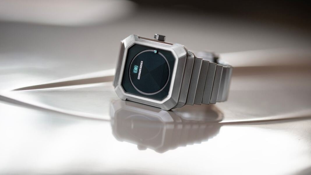 Hautlence Kubera Series 1 in steel lying on a reflective surface, official lifes Hautlence Kubera Series 1 in steel lying on a reflective surface, official lifestyle image