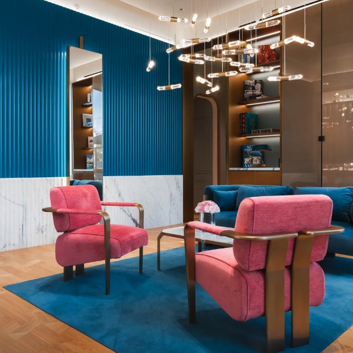 MARLI boutique salon with blue fluted walls, marble and pink armchairs, official image