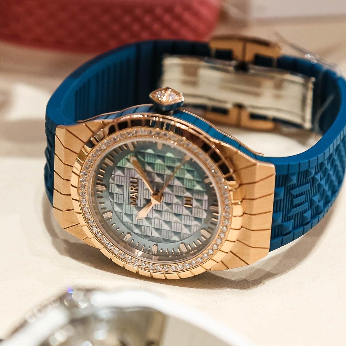 Marli L35 in rose gold on a blue rubber strap