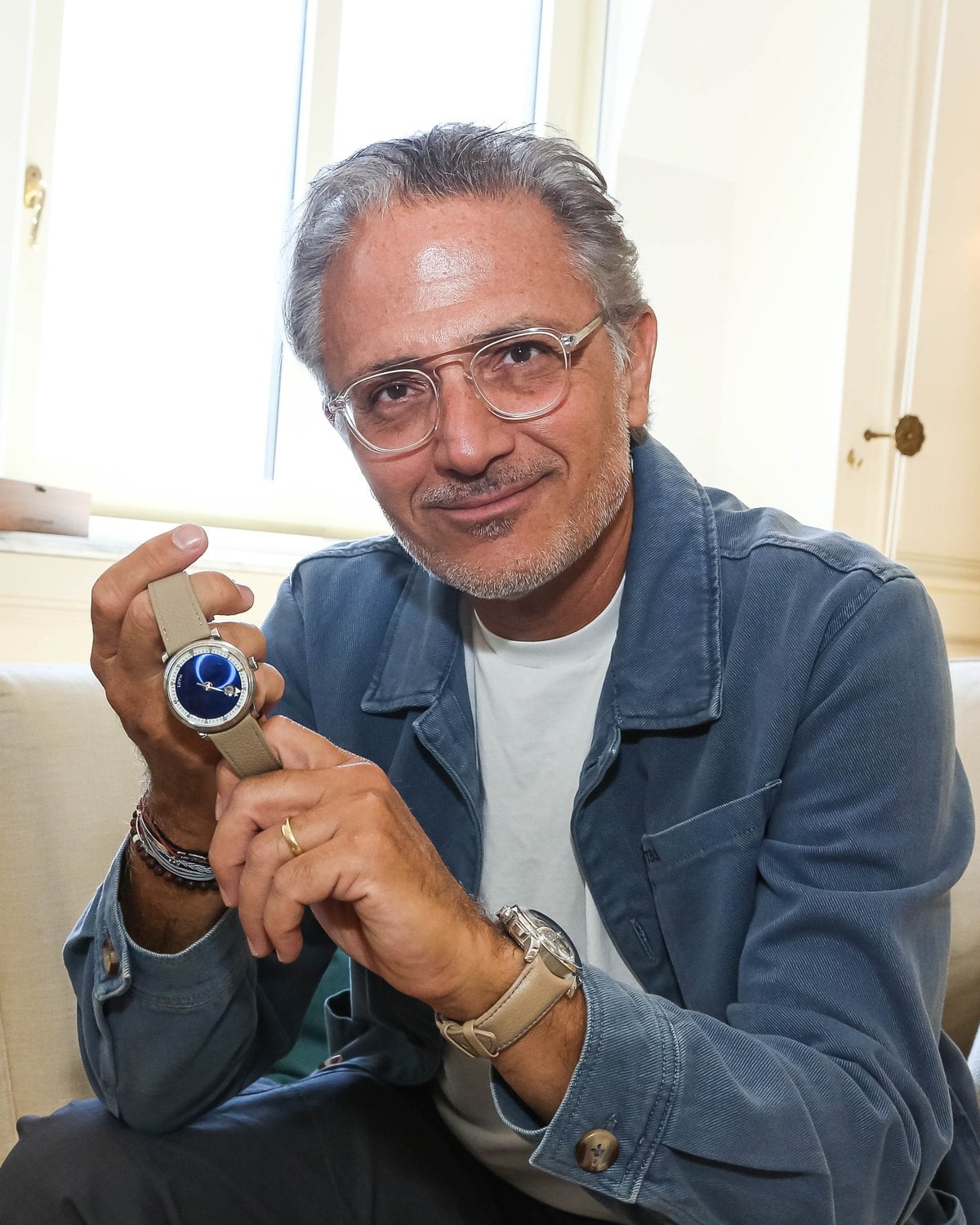 Charris Yadigaroglou, Head of Marketing Communications at MB&F, holding the M.A.D.3 at Geneva Watch Days 2026