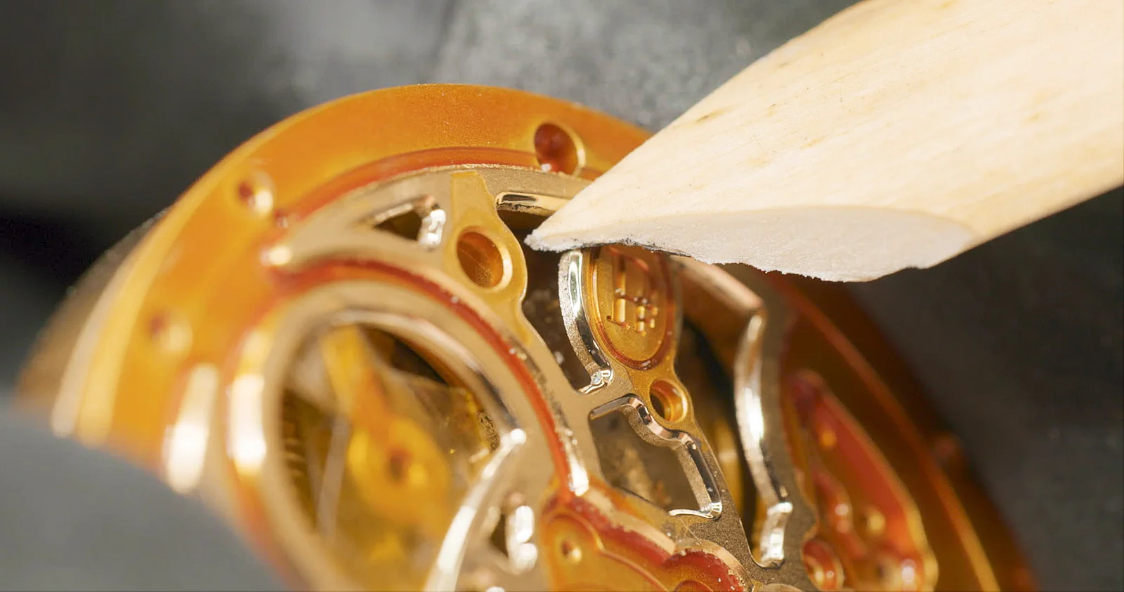 Hand-bevelling of an openworked bridge of the Parmigiani Fleurier calibre PF777
