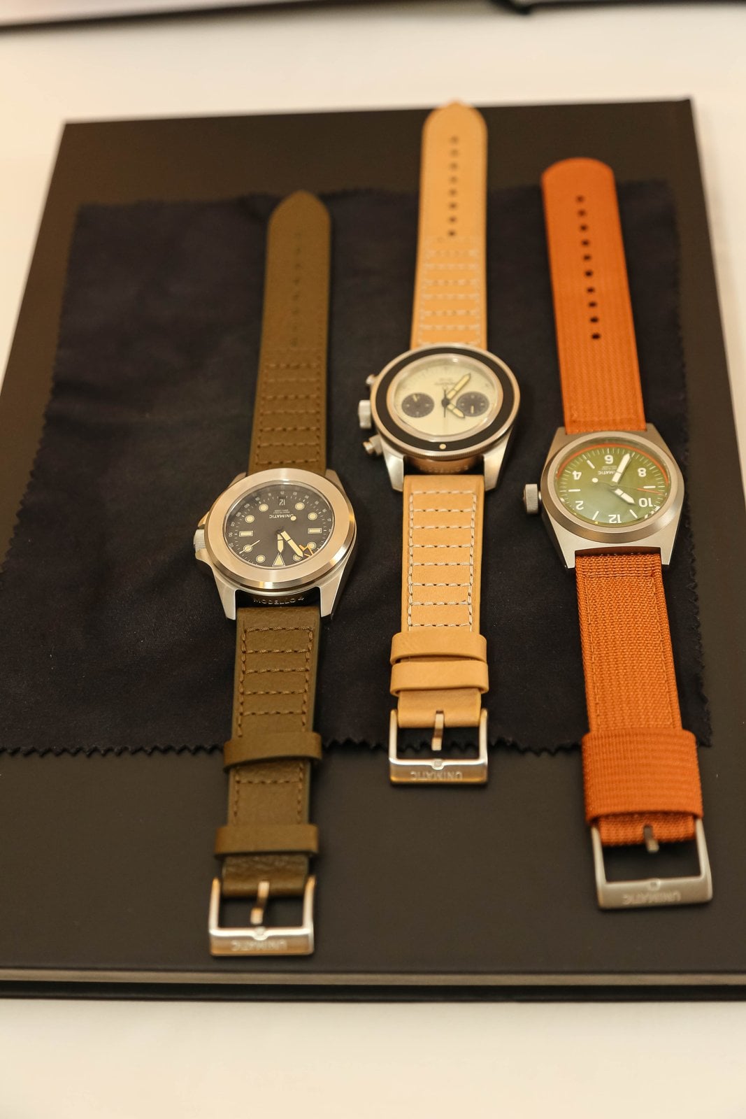 Three Unimatic capsule-edition watches on olive, tan and orange straps at Geneva Watch Days 2026