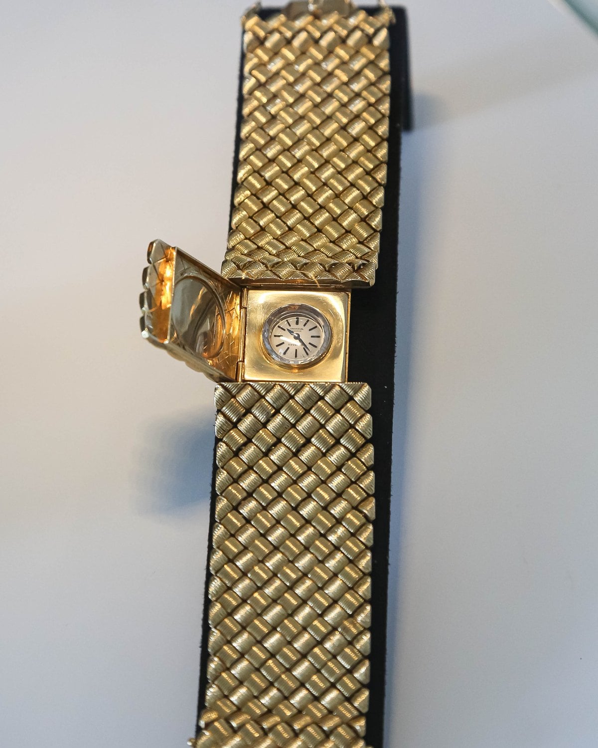Universal Geneve Couture bracelet watch in woven gold with its secret dial open at Geneva Watch Days 2026