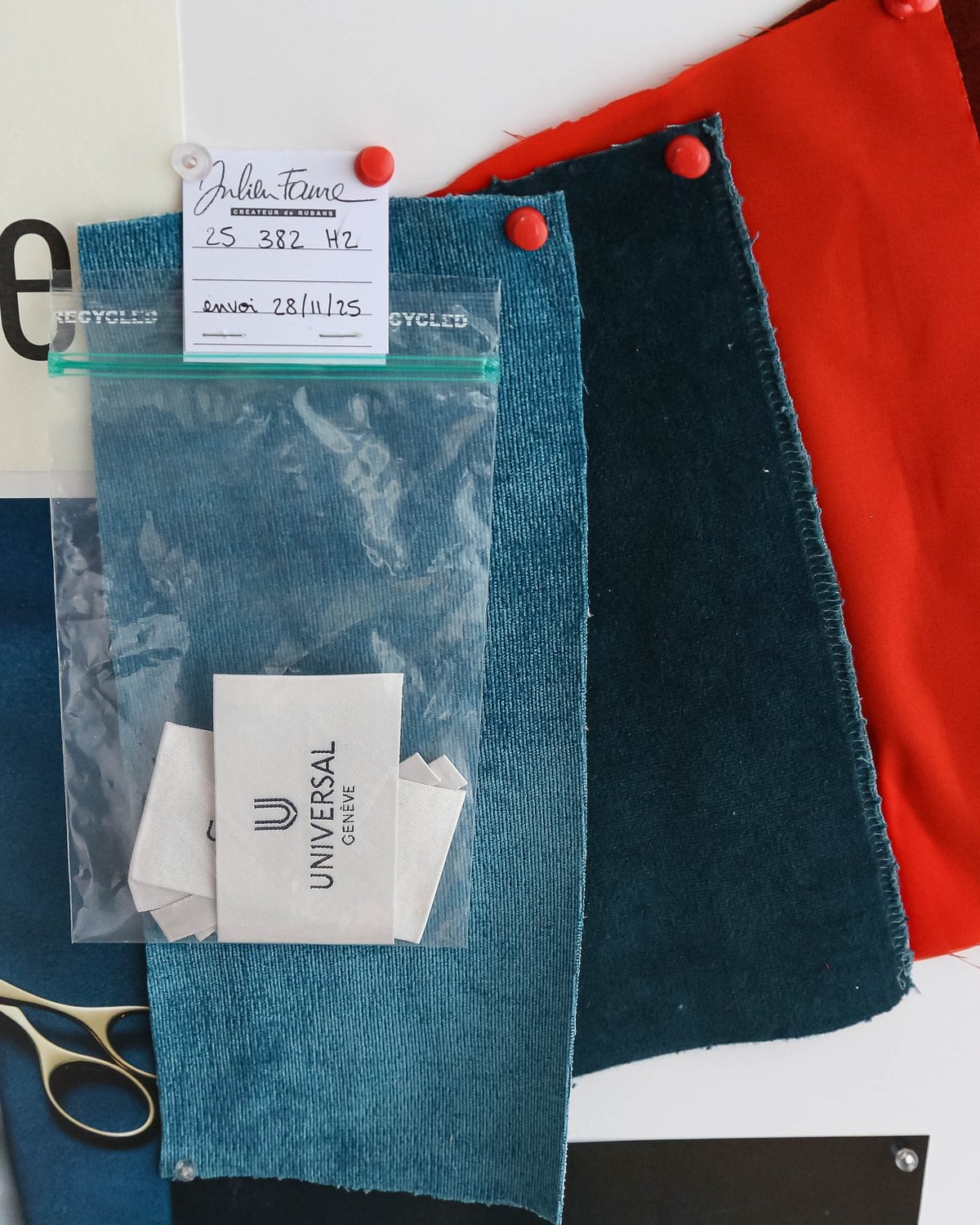 Fabric and leather swatches in teal, red and blue on the Universal Geneve stand at Geneva Watch Days 2026