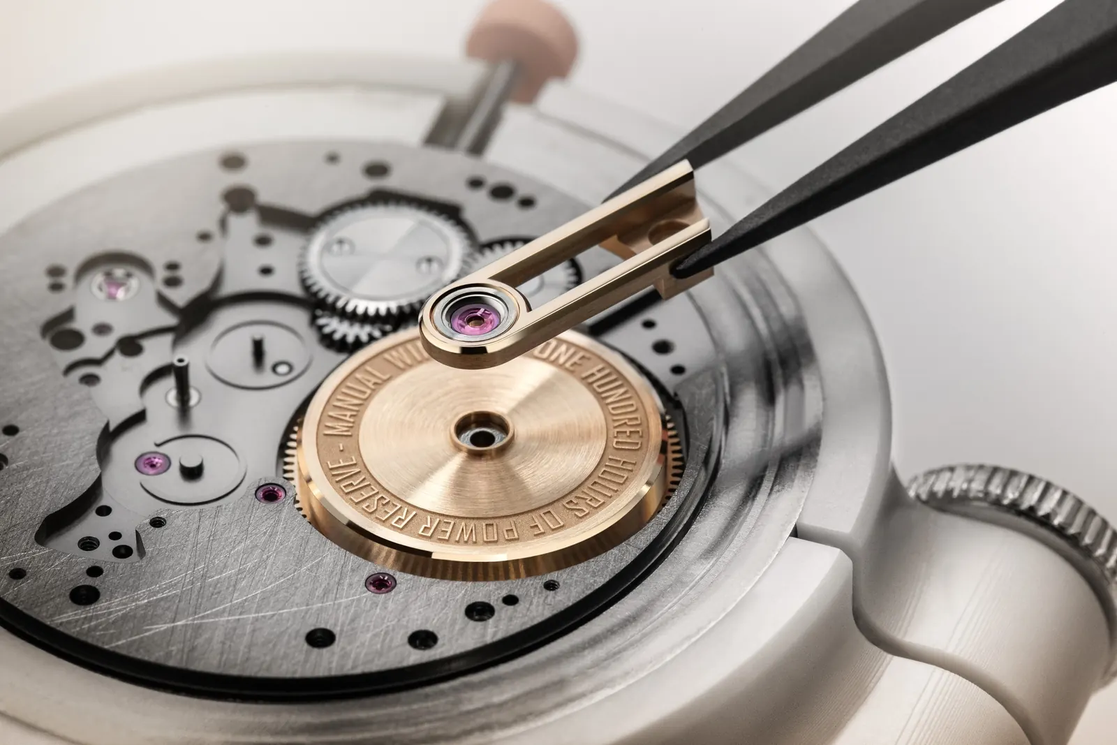 Armin Strom Tribute³ Au750 caseback view revealing three-quarter bridge with clou de Paris guilloché on grey PVD mainplate