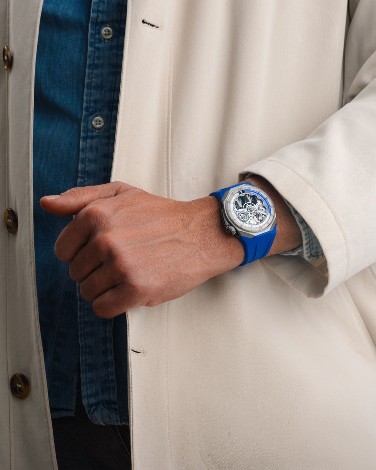 The HYT S1 on the wrist with its blue rubber strap