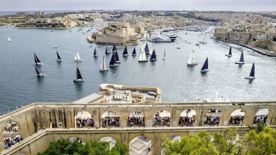 The Rolex Middle Sea Race fleet leaving Grand Harbour in Valletta, Malta, seen from the Upper Barrakka Gardens